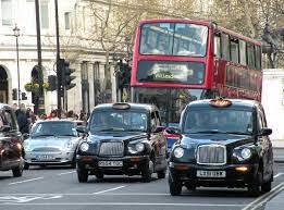 Picture of 2 black taxi cabs and a red double decker bus