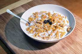 White bowl with cornflakes and a spoon